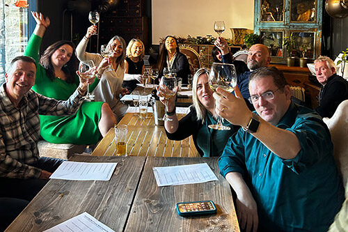 People sat around tables tasting wine at event